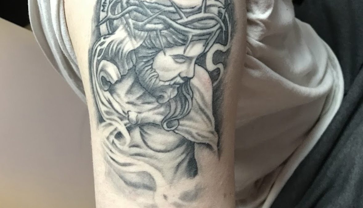 The Art Behind a Detailed Black and Grey Jesus Tattoo