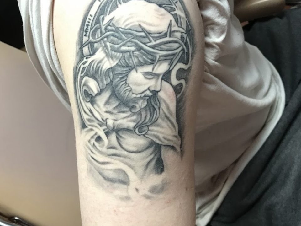 The Art Behind a Detailed Black and Grey Jesus Tattoo